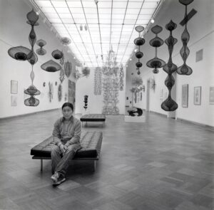 Ruth Asawa in the gallery with her artwork