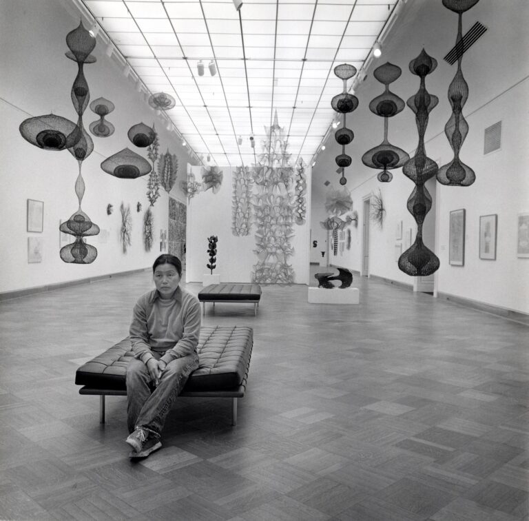 Ruth Asawa in the gallery with her artwork