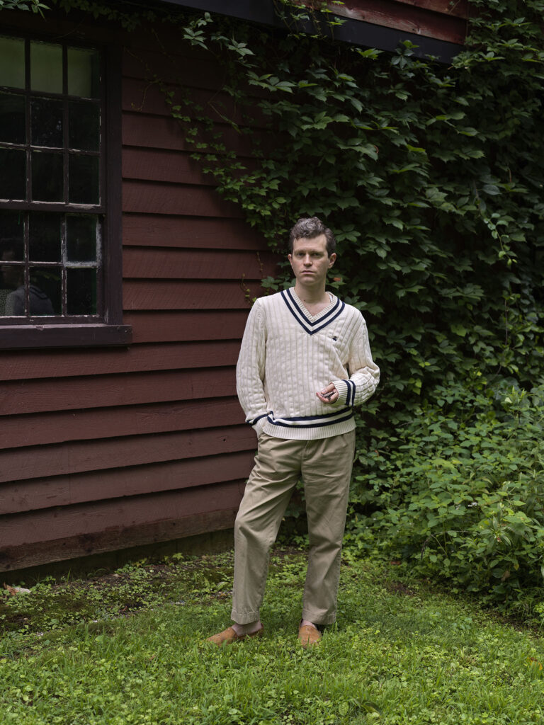 Sam McKinniss outside his art studio