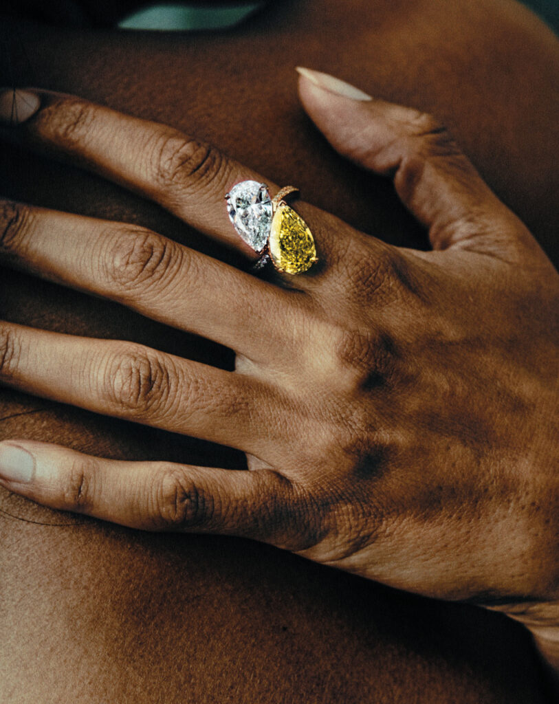 Fancy Vivid Yellow and White Pear ShapeDiamond Cross Over Toi et Moi Ring set in yellow and white gold.