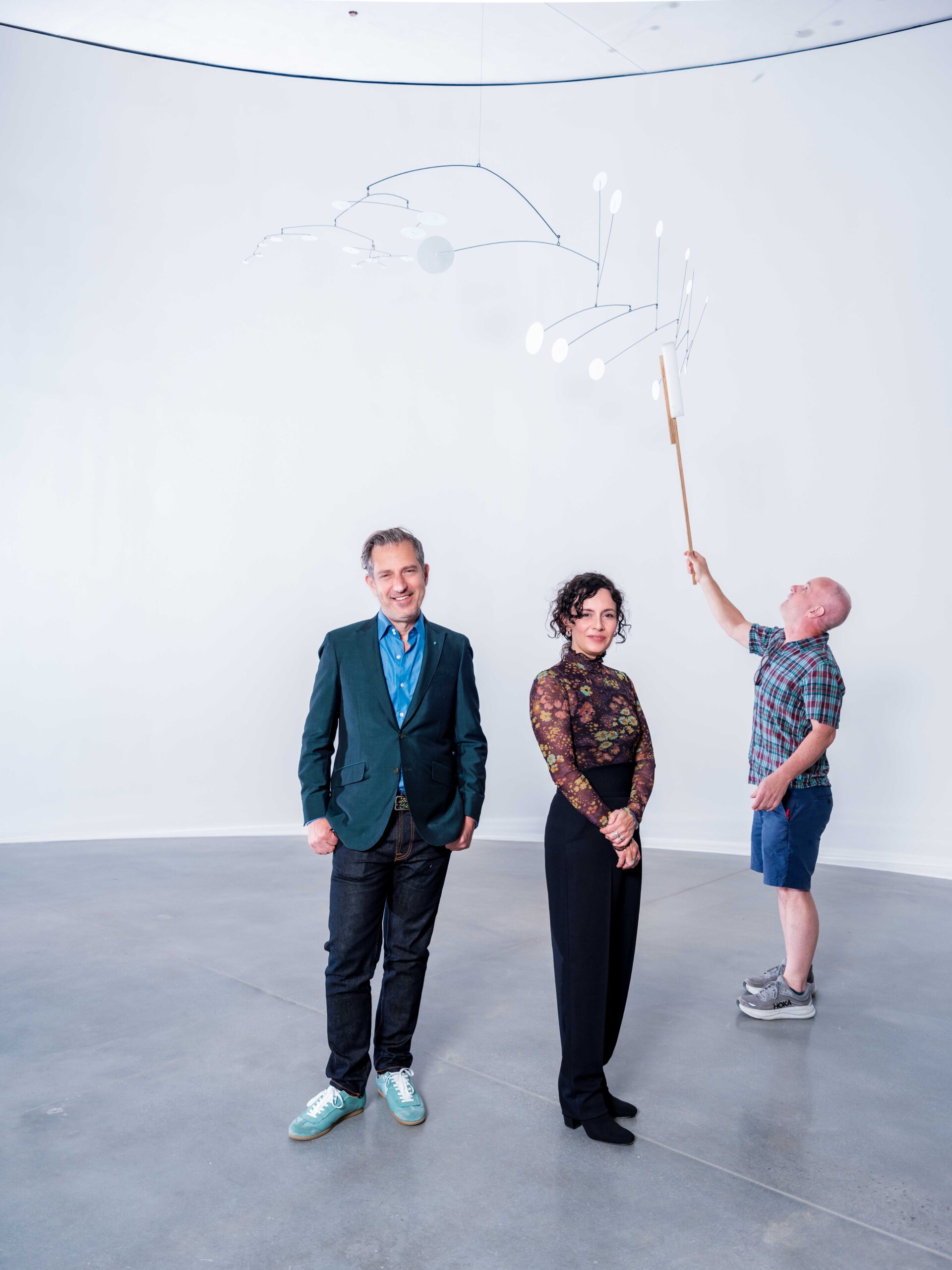Alexander S.C. Rower, Julianna Berrío, and a member of the art installation team at Calder Gardens.
