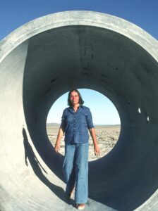 Nancy Holt standing in one of the Sun Tunnels in Utah's Great Basin Desert in 1976