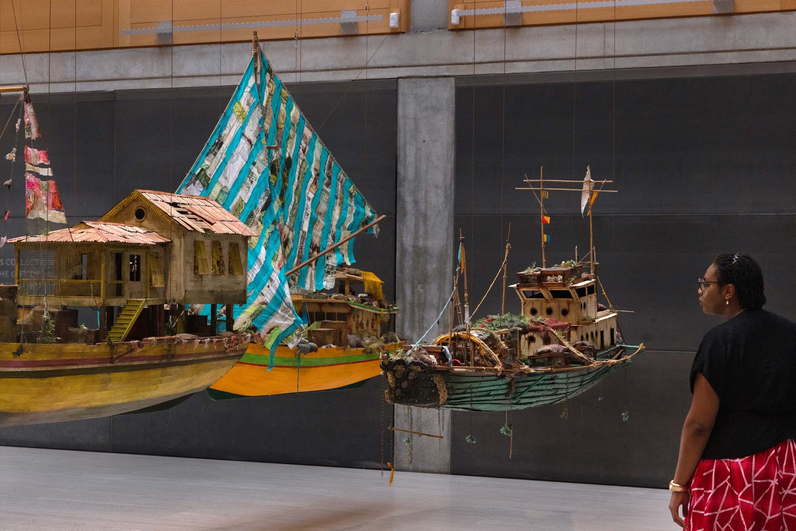 Visitor with The Survivor, The Relic, and Desire by Hew Locke, installed at the Entrance Court of the Yale Center for British Art
