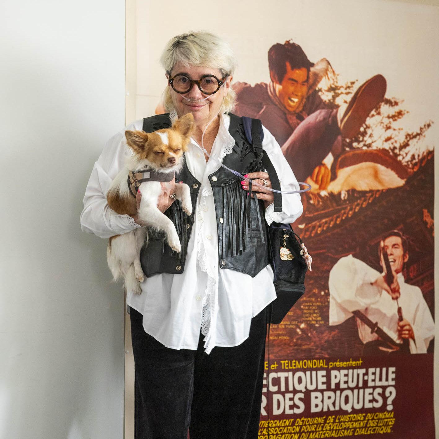 Florence Bonnefous in front of  a vintage, original poster from the situationist 1973 film, La dialectique peut-elle casser des briques. Photography by Bruno Serralongue and courtesy of the gallerist. 