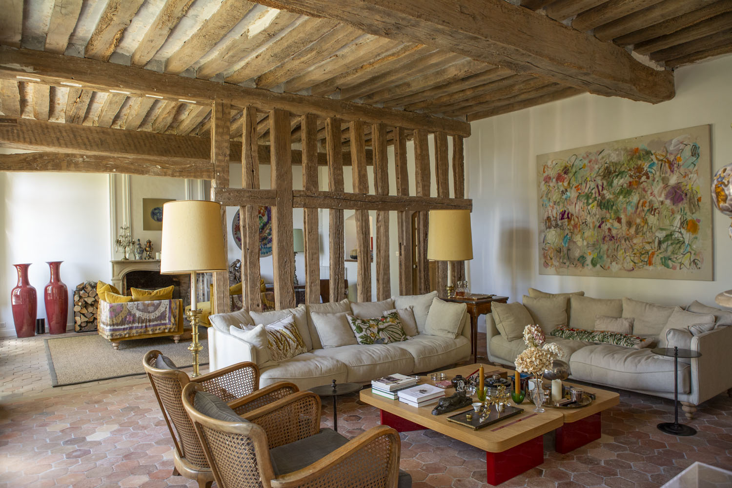 The grand salon features work from the community, including a 2021 painting by Claudie Laks and a stainless steel end table from Romain Barré. De Buffévent designed her coffee table, which was produced by Romain\\\