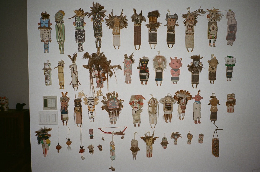 Ah, my kachinas. These are made by the Hopi. They represent different mythical deities in the Hopi mythology and culture. My husband and I used to go to the Hopi reservations in Arizona back when I lived in LA, and we got to know some people there. We became friendly with a couple who sold these. He’s white and she was from the Butterfly clan, and this was their business. When I first met them, I saw their collection of kachinas—incredible. They had a trailer that was covered with them, and their home was as well. There was a story to most of them, and that inspired me to start a collection. Every visit, I would pick up a few that I liked. It was when I lived in LA, so the late ’80s.