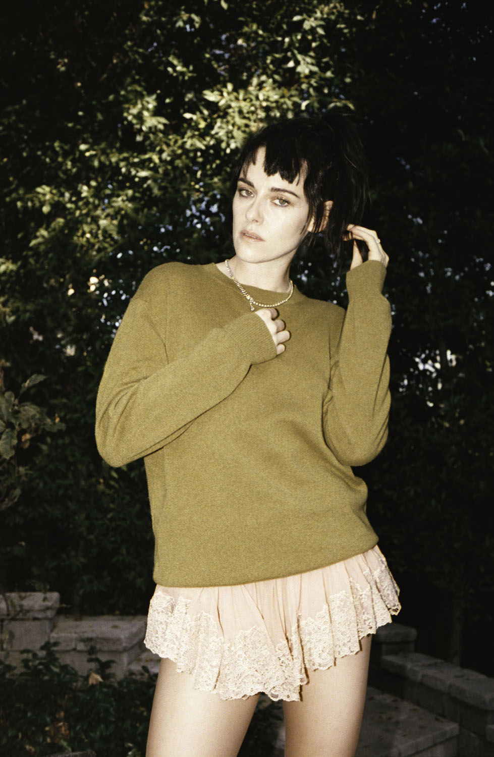 Kristen Stewart wears a top and shorts by Saint Laurent with a necklace by Chanel.