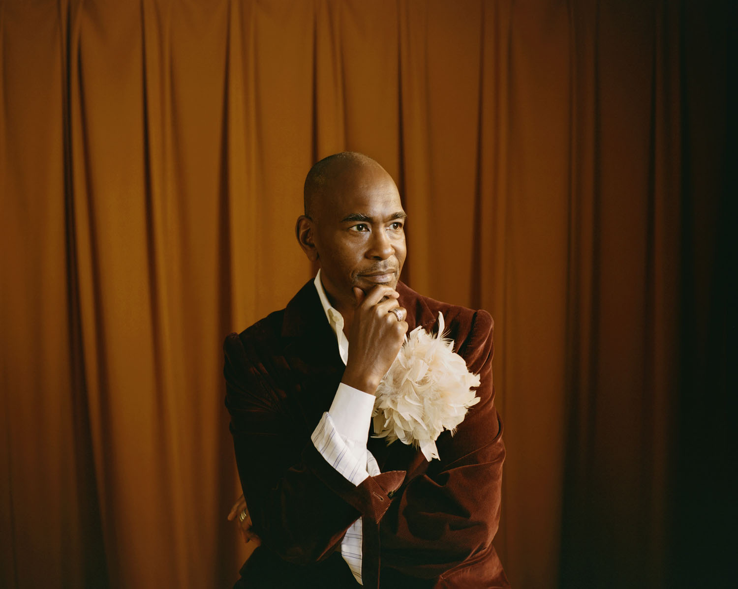  Paul wears a jacket and shirt by Willy Chavarria. Floral accent is stylist’s own