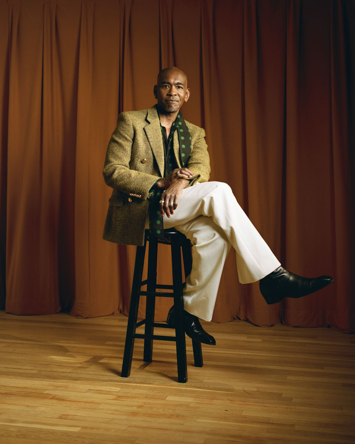 Paul wears a jacket, shirt, and pants by Valentino with shoes by Jimmy Choo.