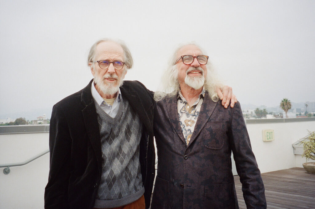Robert Crumb and George DiCaprio stand arm-in-arm on the David Zwirner rooftop.