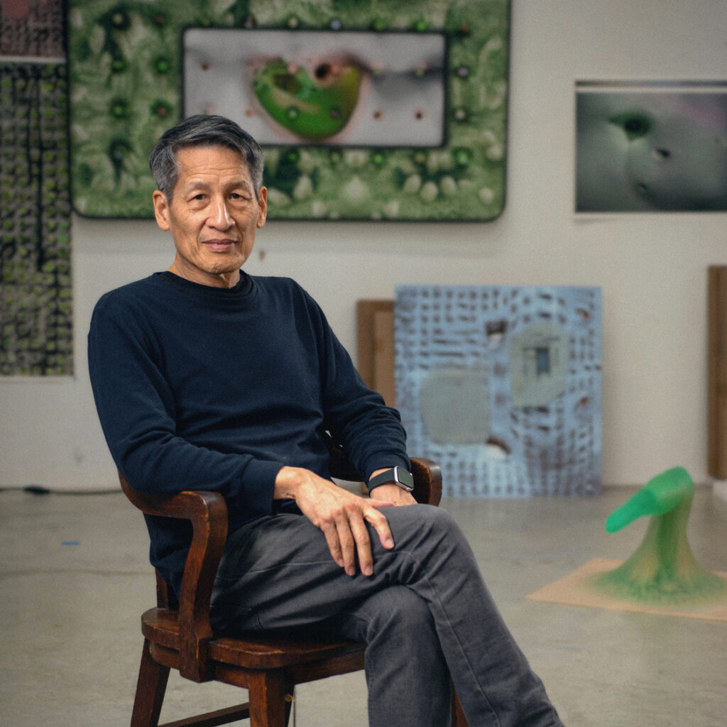 Tishan Hsu sitting in a chair in his artist's studio.