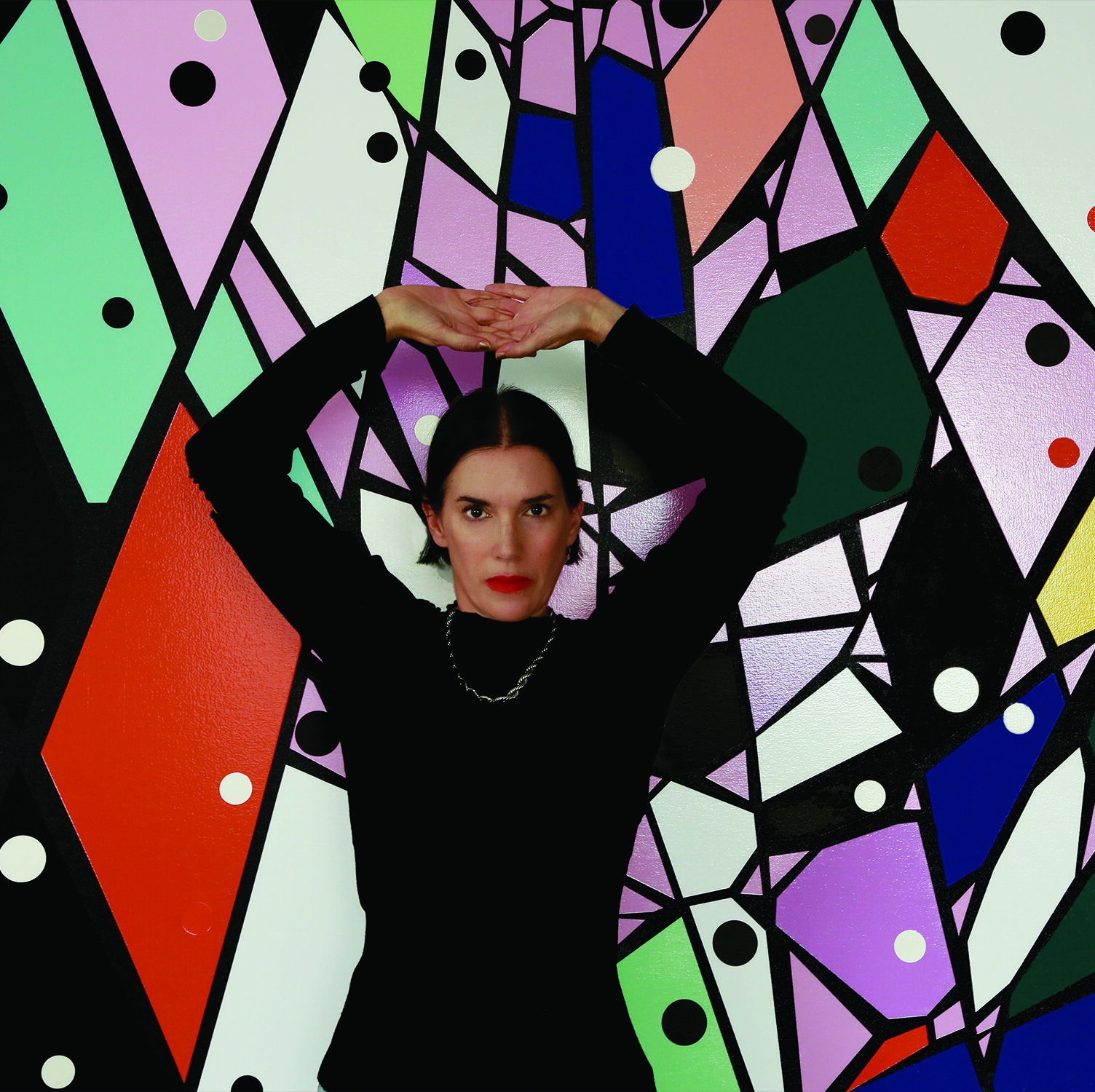 Sarah Morris in front of mural. 