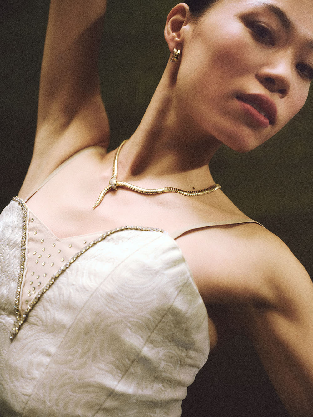 Serpenti Tubogas yellow goldnecklace with demi pavé diamonds and black onyx eyes, and B.zero1 yellow gold hoop earrings with pavé diamonds.