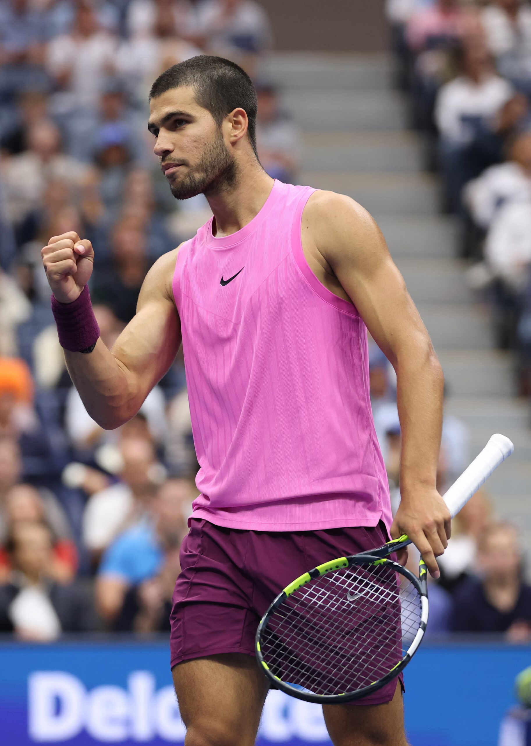 Carlos Alcaraz in a pink NIke tank top at the 2025 US Open, photography by Clive Brunskill and courtesy of Getty Images