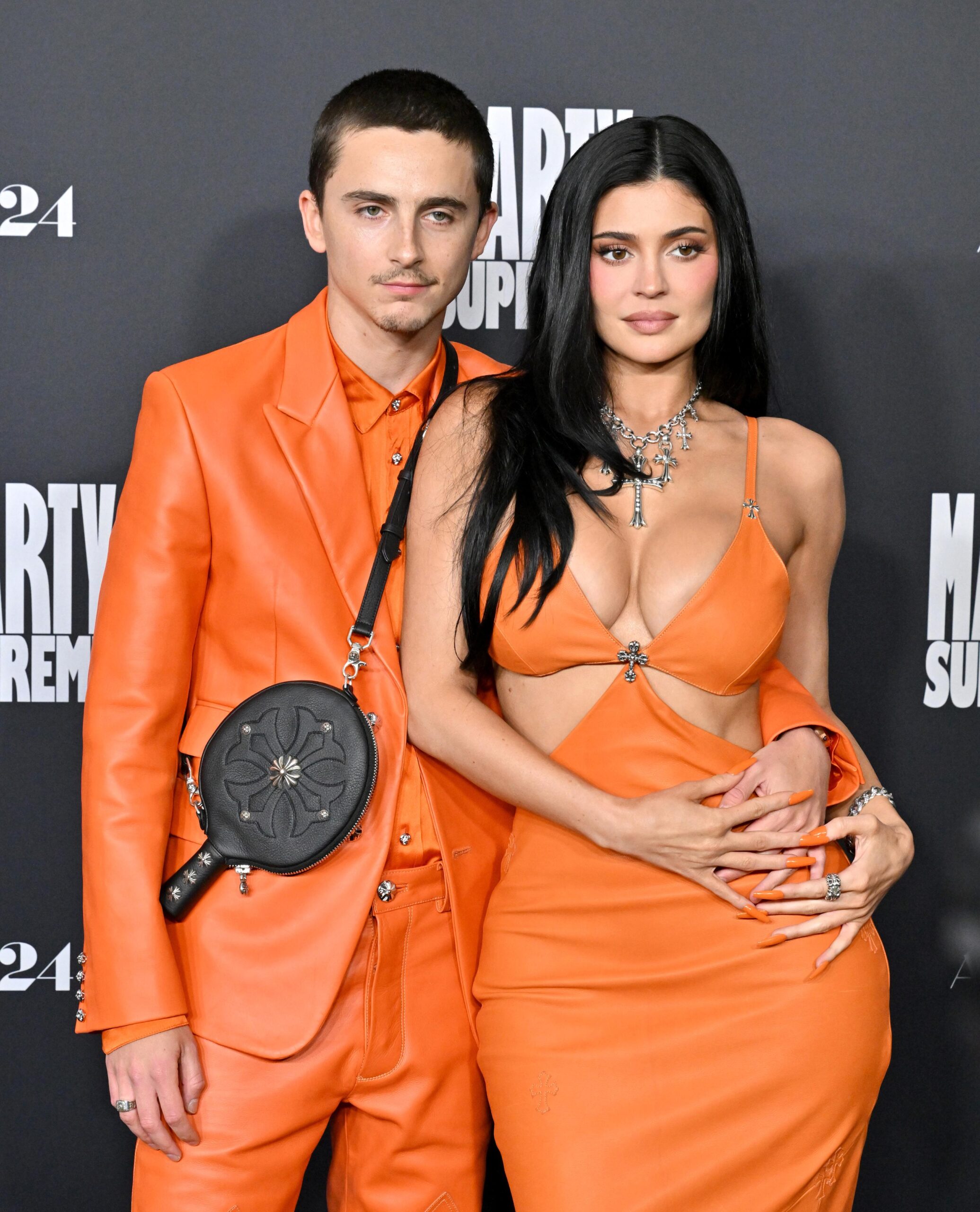 Timothée Chalamet and Kylie Jenner in matching orange looks at a premiere event for the Marty Supreme film, photography by Axelle Bauer Griffin/FilmMagic and courtesy of Getty Images