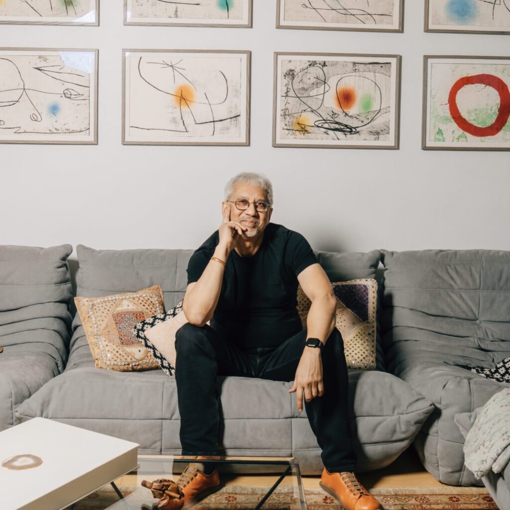 Portrait of Debraj Ray with Joan Miro's Lapidario at his New York apartment