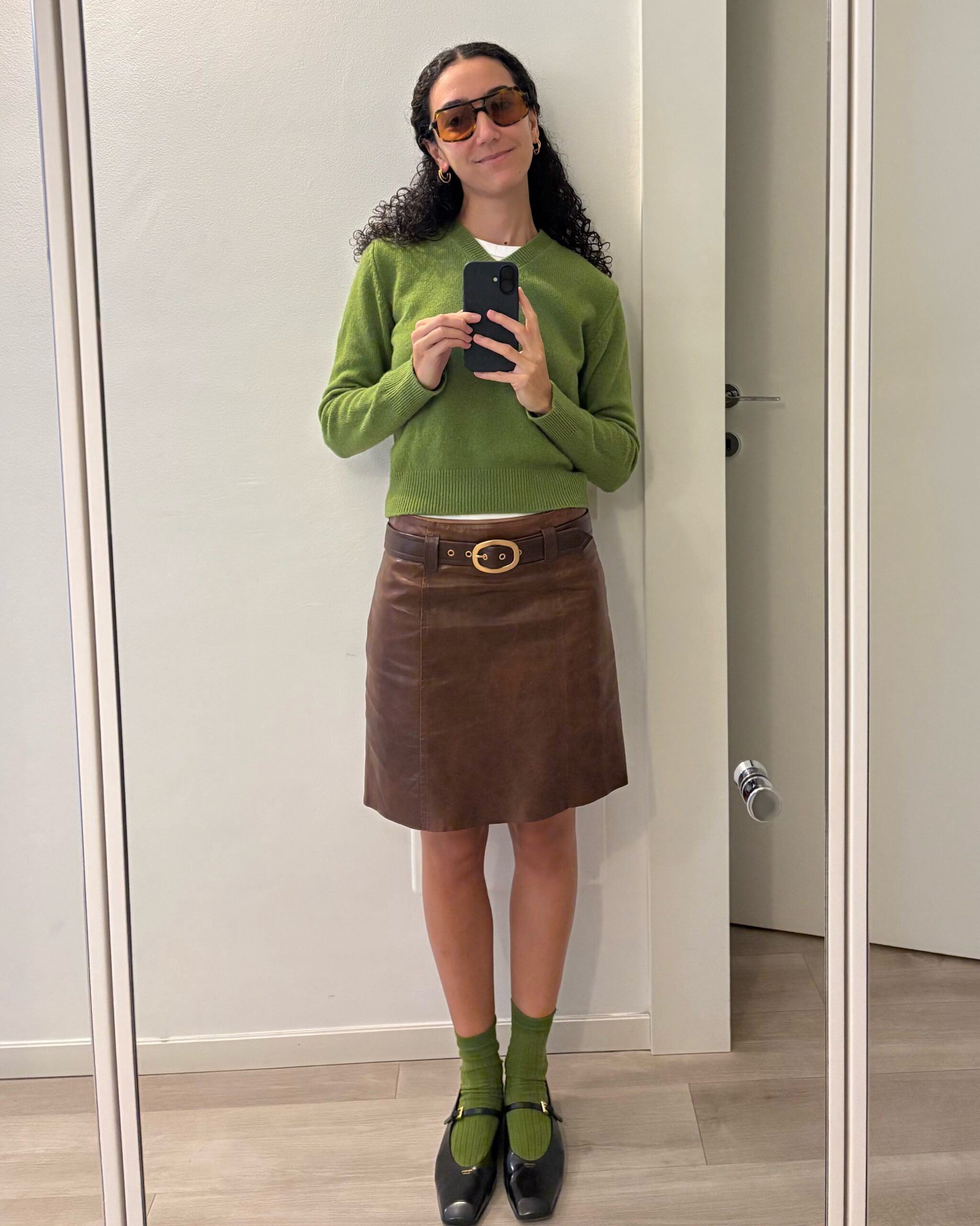 Emilia Petrarca in vintage sunglasses from Veneta Ottica and a vintage leather Prada skirt from The RealReal