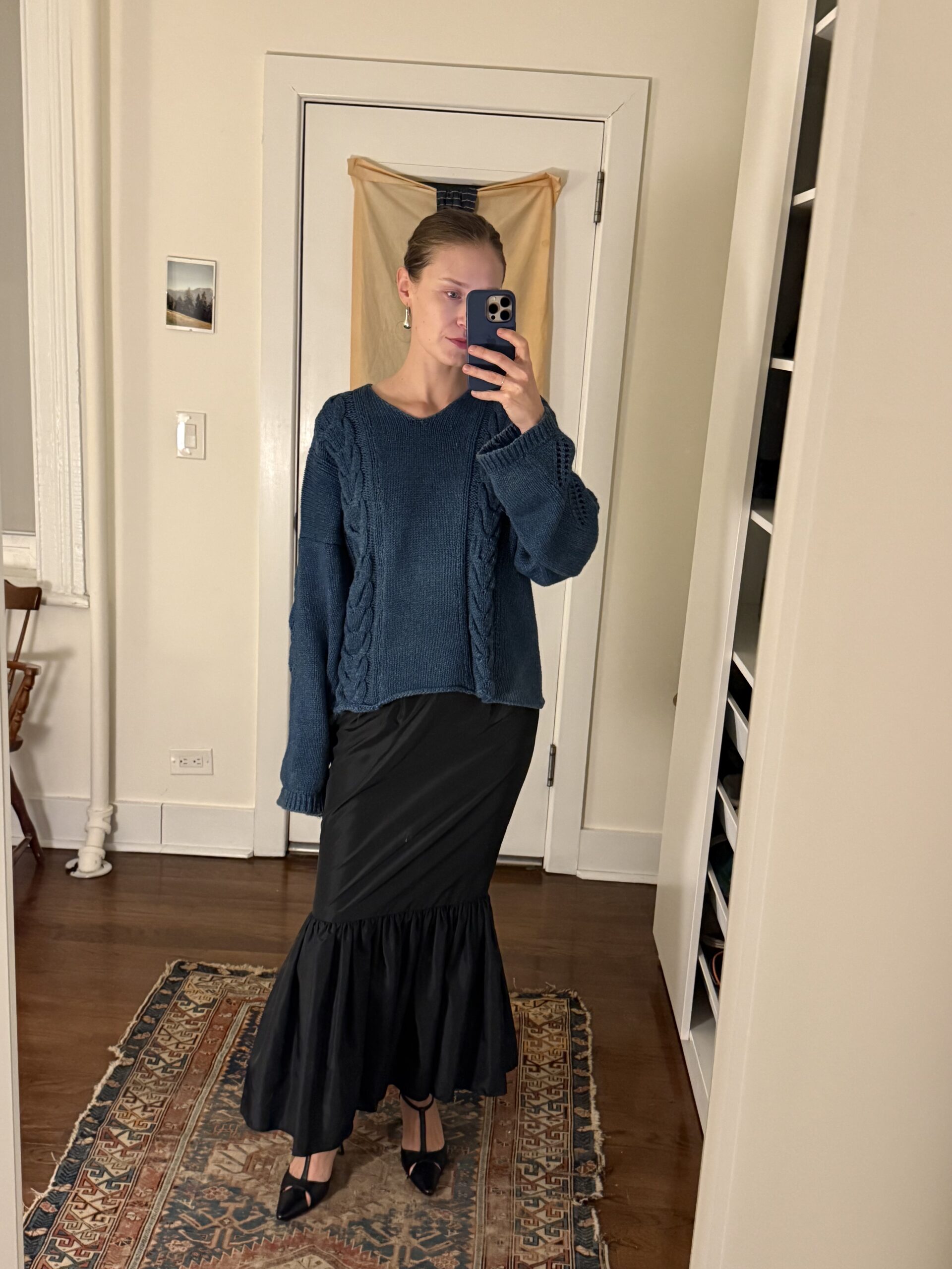 Lauren Schofield in a handmade skirt and earrings from Ancien, Yohji Yamamoto sweater from Thanx God I'm A VIP, and Manolo Blahnik heels from The RealReal