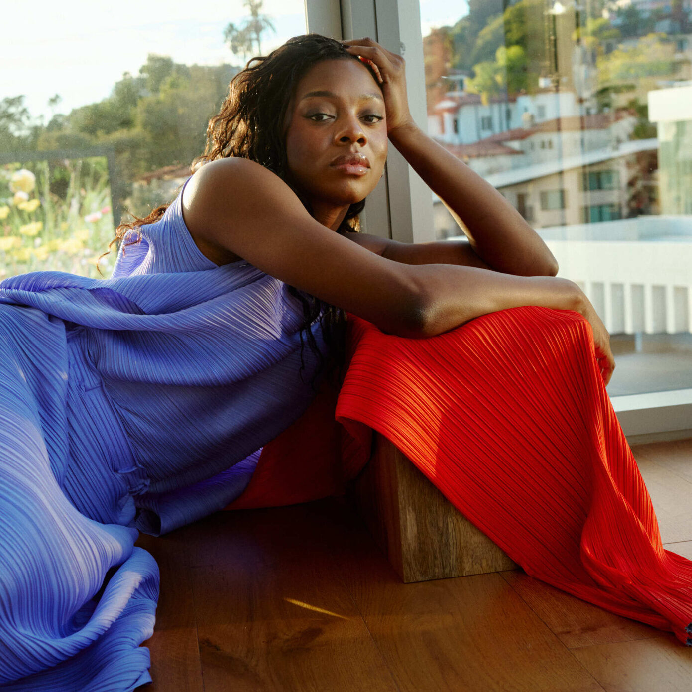 Director Nia DaCosta shot by Brad Torchia, wearing a top and skirt by Issey Miyake.