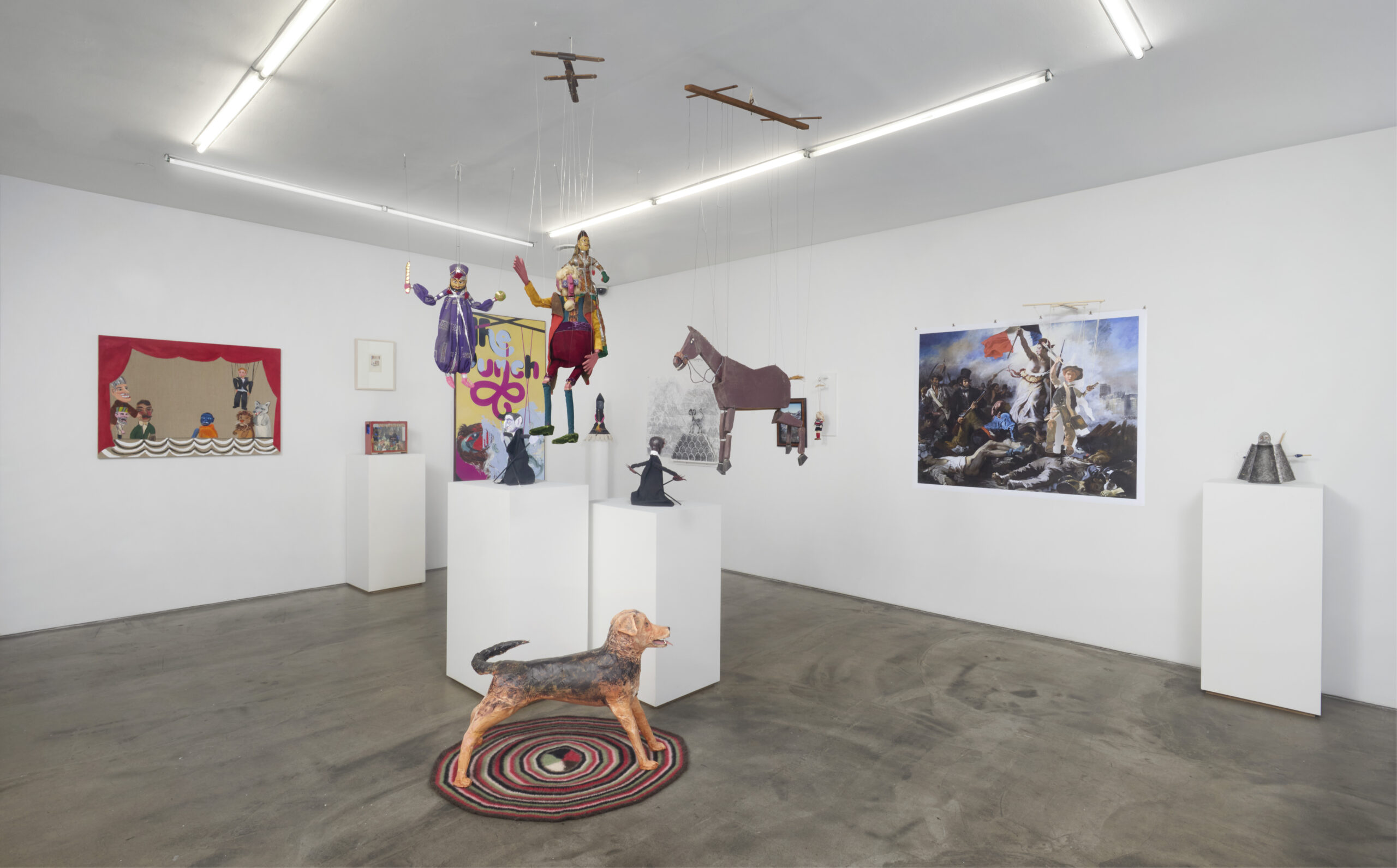 Installation shot of The Nagy Marionette Company: A 75th Anniversary Exhibition, featuring Sarah McEneaney's Birdie, 2003 and Tabboo!'s painting, Puppet Show, 2017