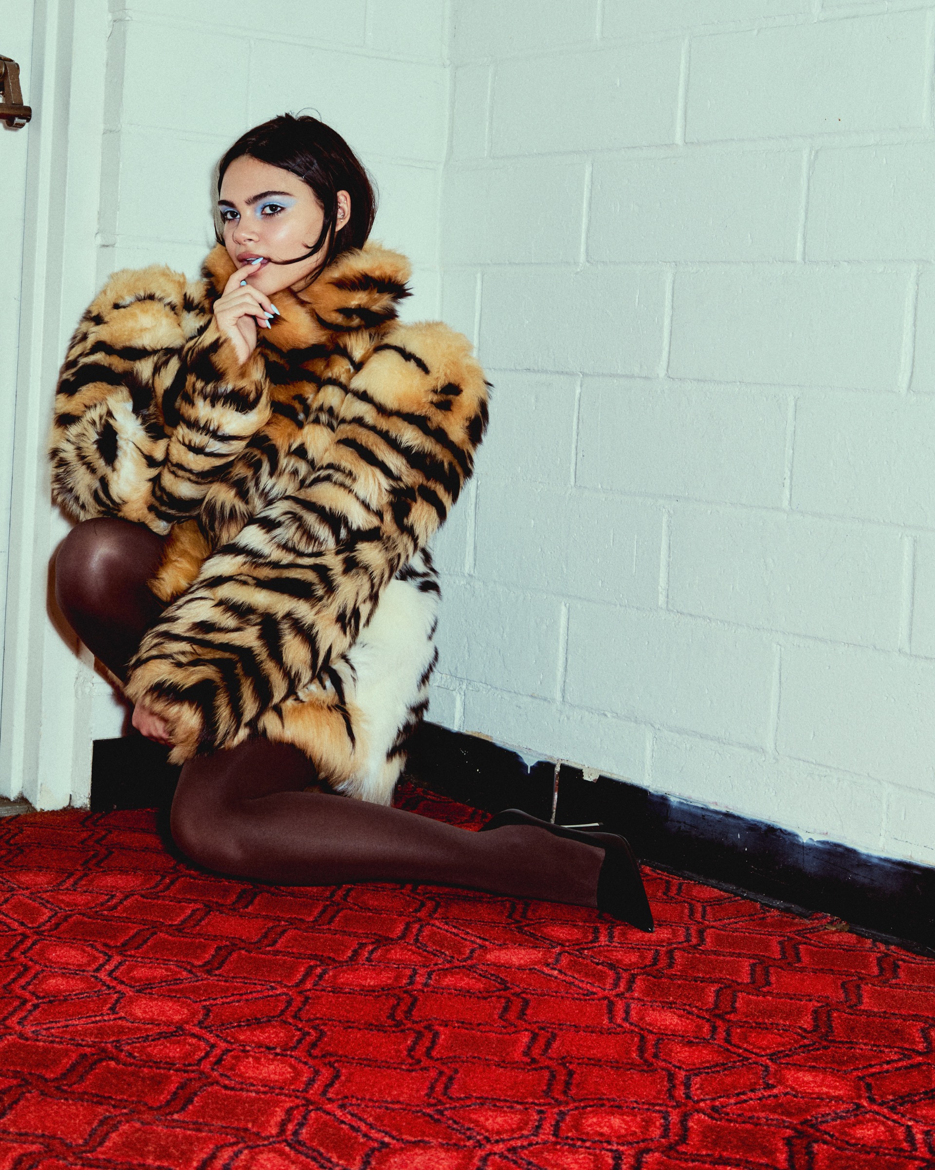 Barbie actress Ariana Greenblatt wears a tiger striped coat by Gucci.