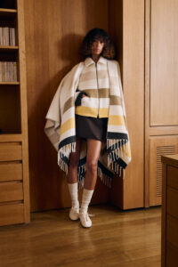 A Kenzo model wears a wool striped caplet in the fashion brand's founder's Paris home.