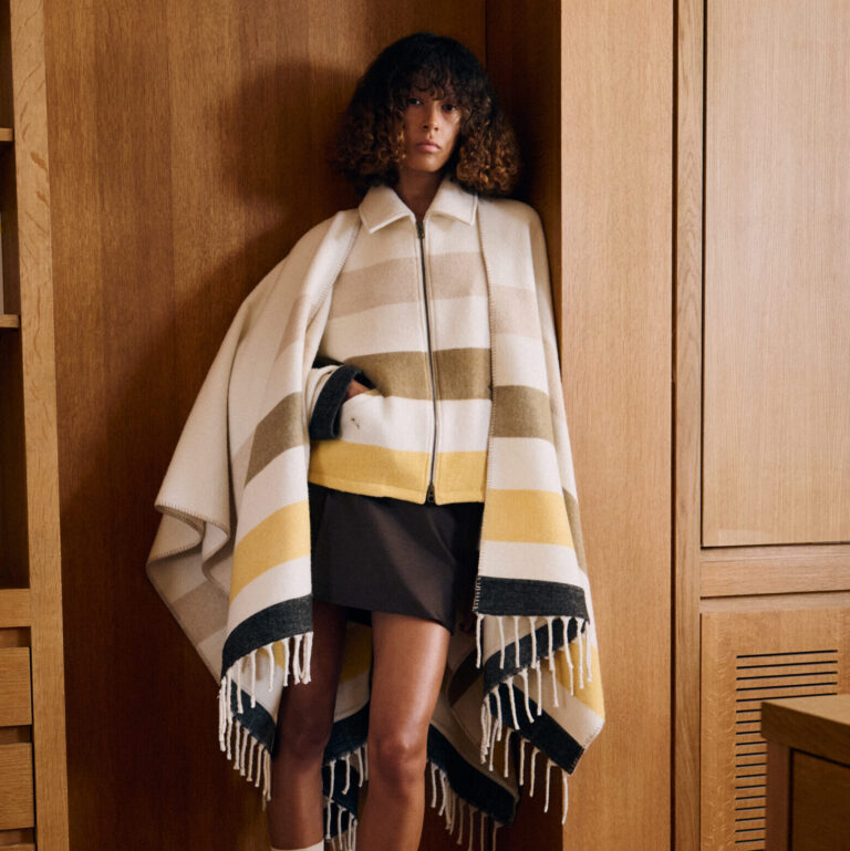 A Kenzo model wears a wool striped caplet in the fashion brand's founder's Paris home.