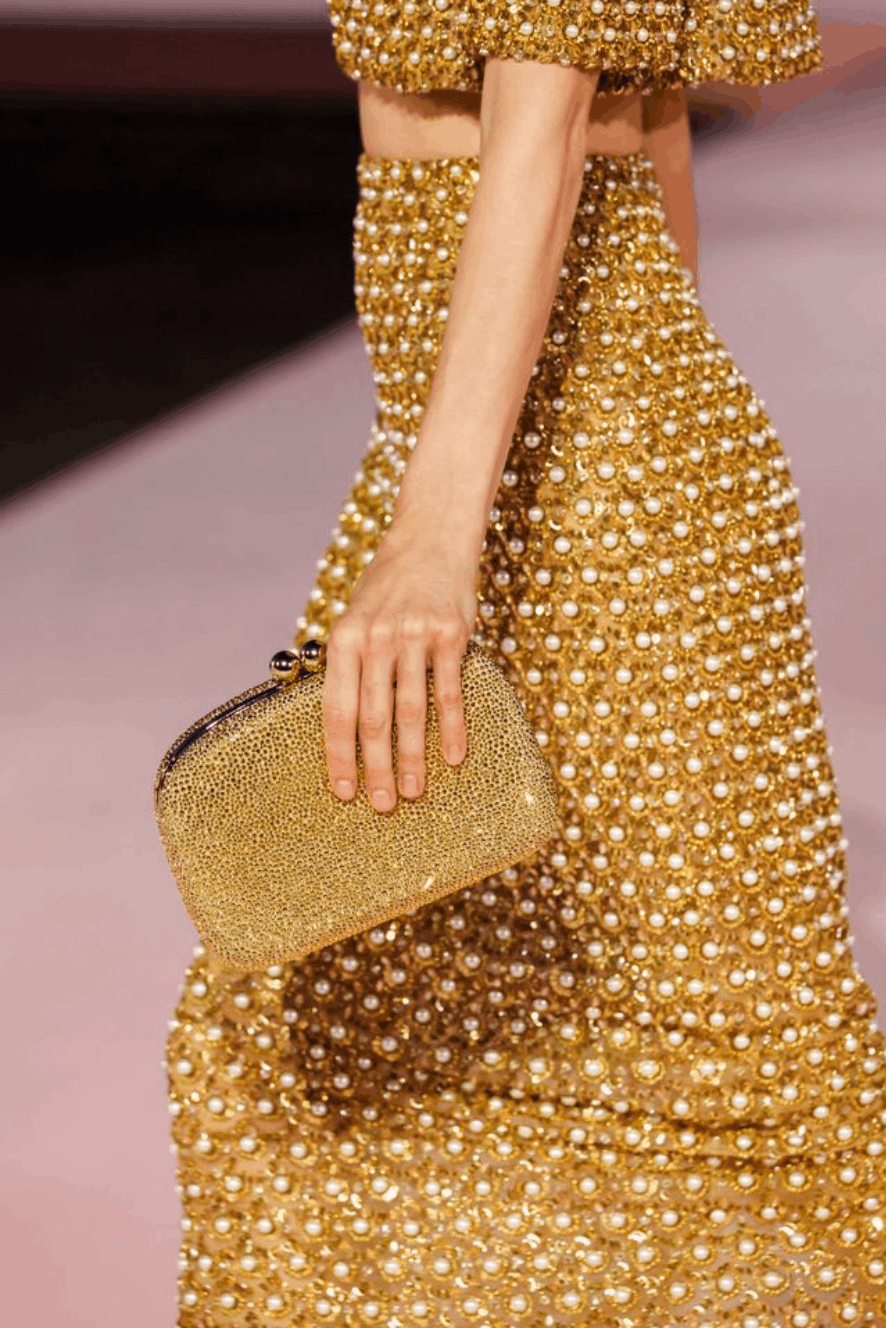 A gold bejeweled clutch from the Spring/Summer 2026 collection for Carolina Herrera designed by Wes Gordon.