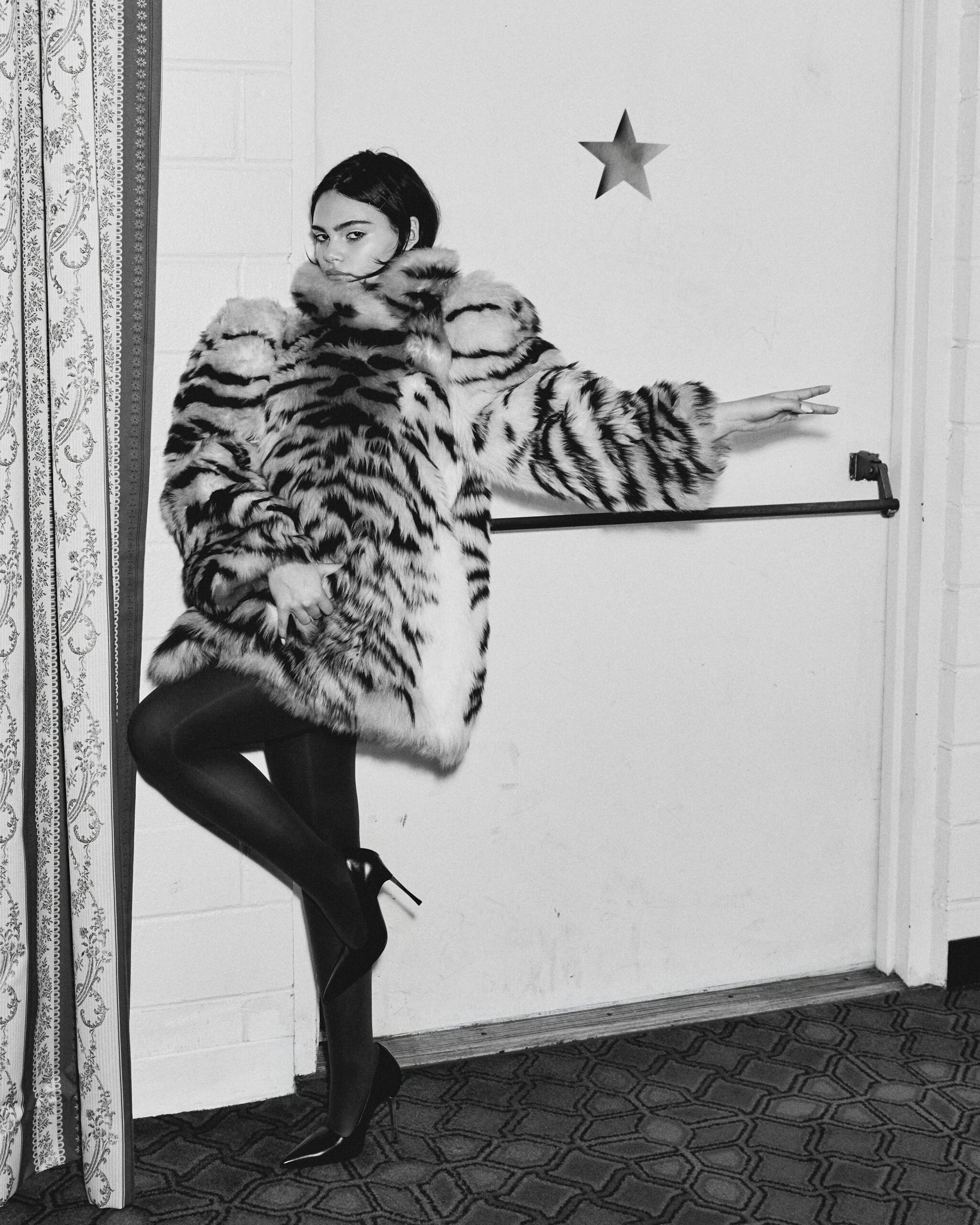 Barbie actress Ariana Greenblatt wears a tiger striped faux fur coat from Gucci.