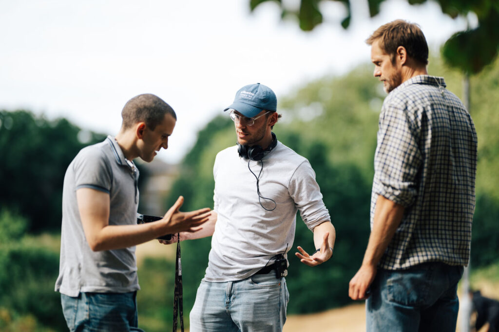 Harry Melling, Harry Lighton, and Alexander Skarsgård on the set of Pillion.