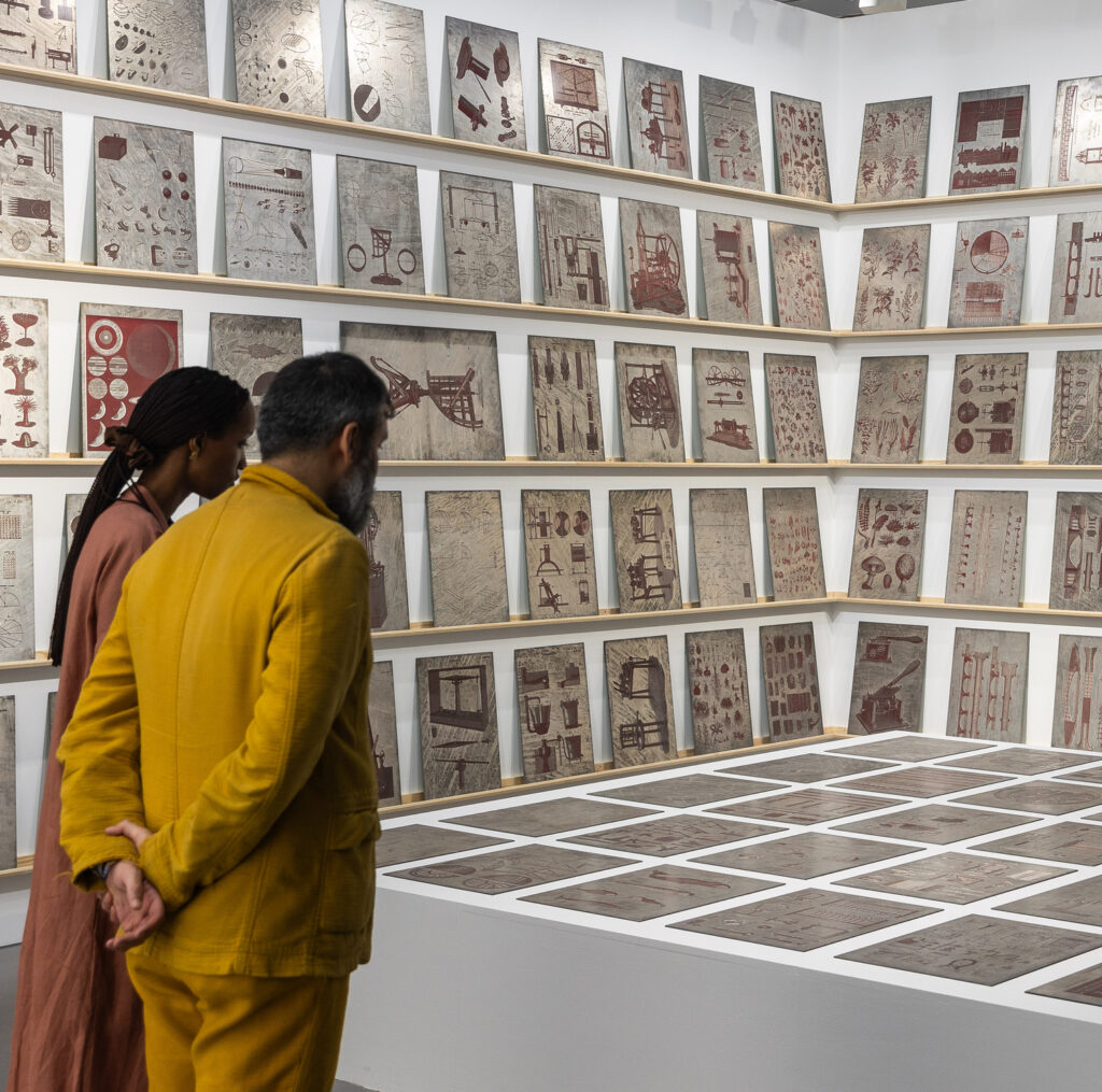 The booth of Galerie Thomas Schulte at Art Basel Qatar with the work New Edinburgh Encyclopedia by Matt Mullican