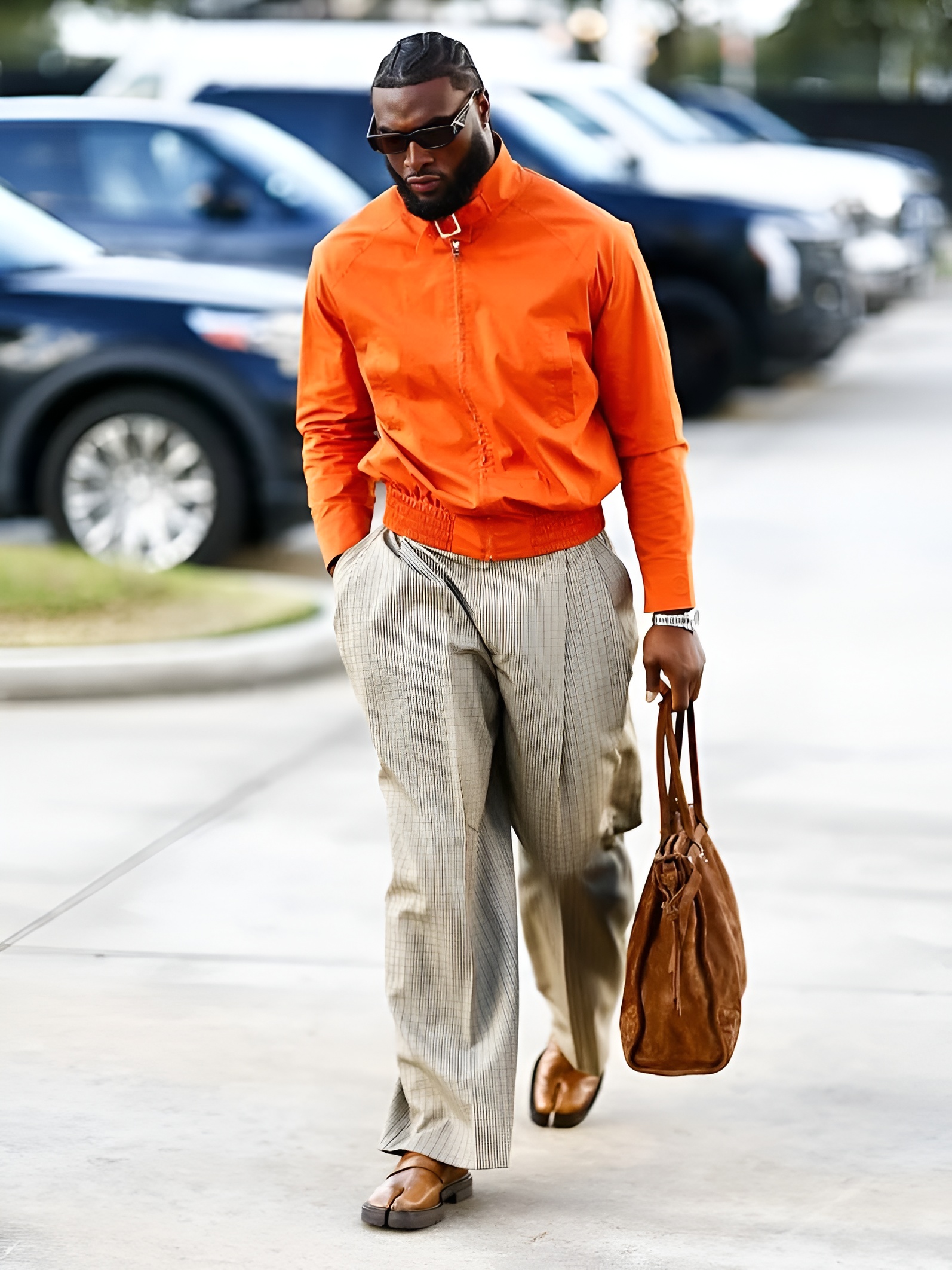 Will Anderson Jr. of the Houston Texans in an orange jacket and brown Tabi shoes