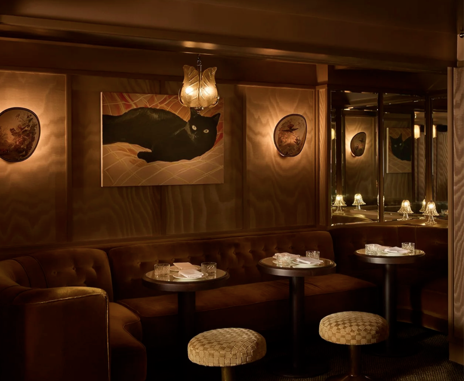 The seating area of People's, featuring their art collection and dim, warm lighting