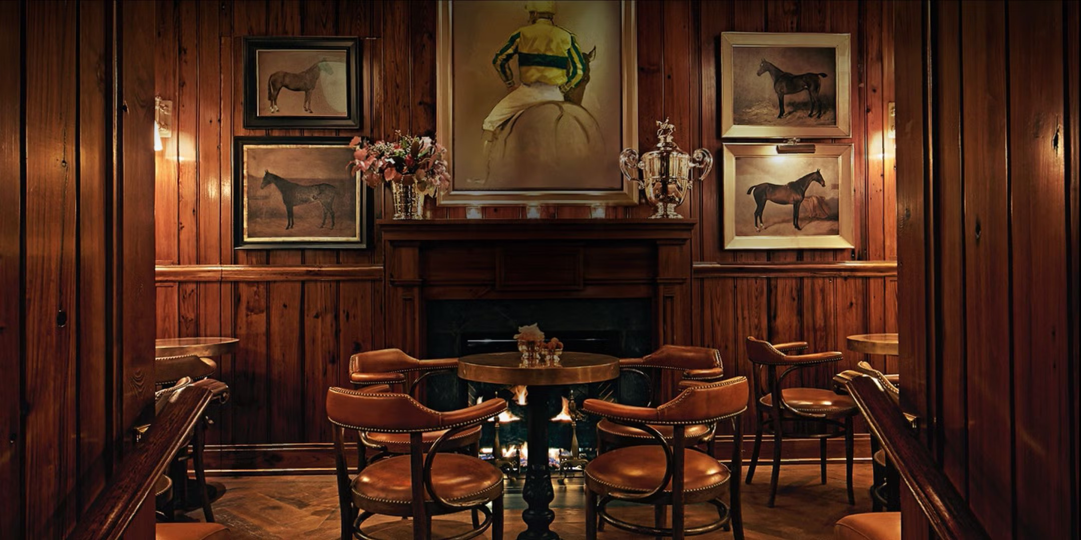 A seating arrangement and artwork at the Polo Bar