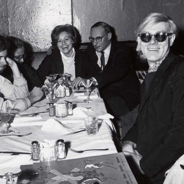 Andy Warhol and friends sit for a meal at the Chelsea Hotel