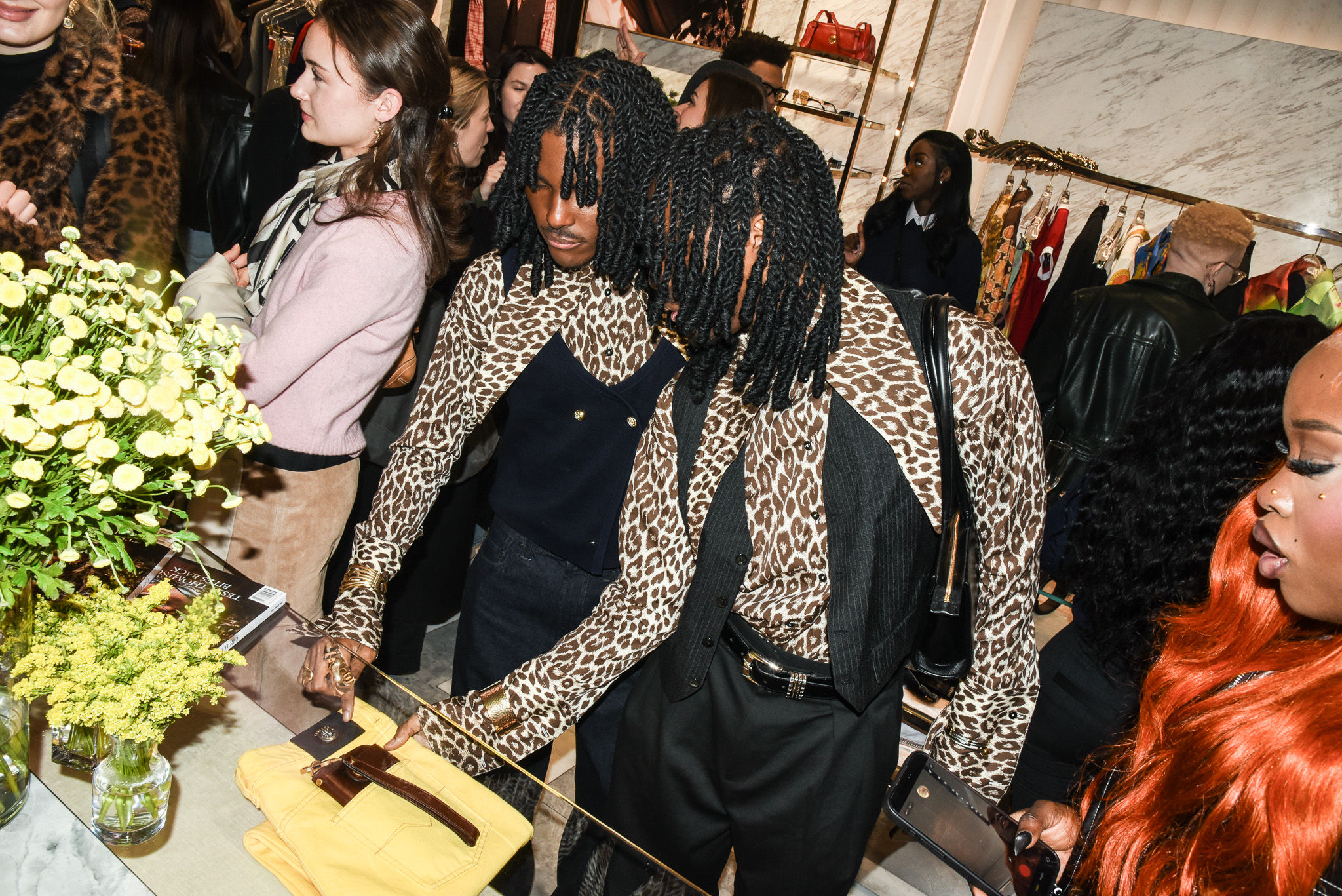 curtis-carlsen-atanga Curtis and Carlsen Atanga look at a pair of Versace pants at the store event with CULTURED