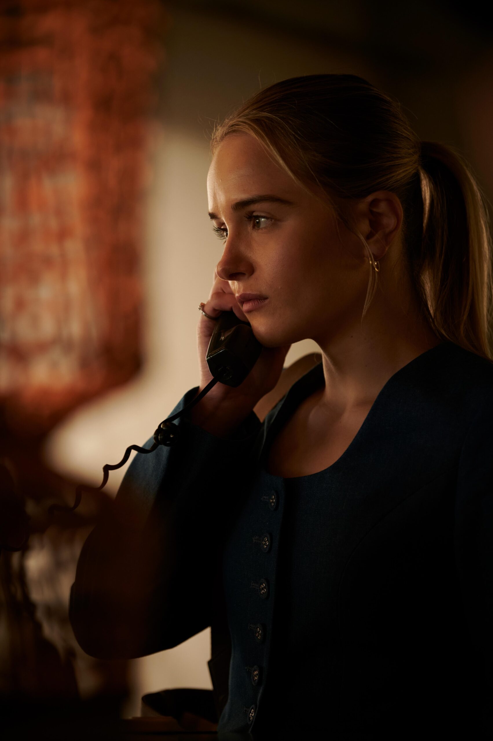 Miriam Petche takes a call during a scene in Industry on HBO