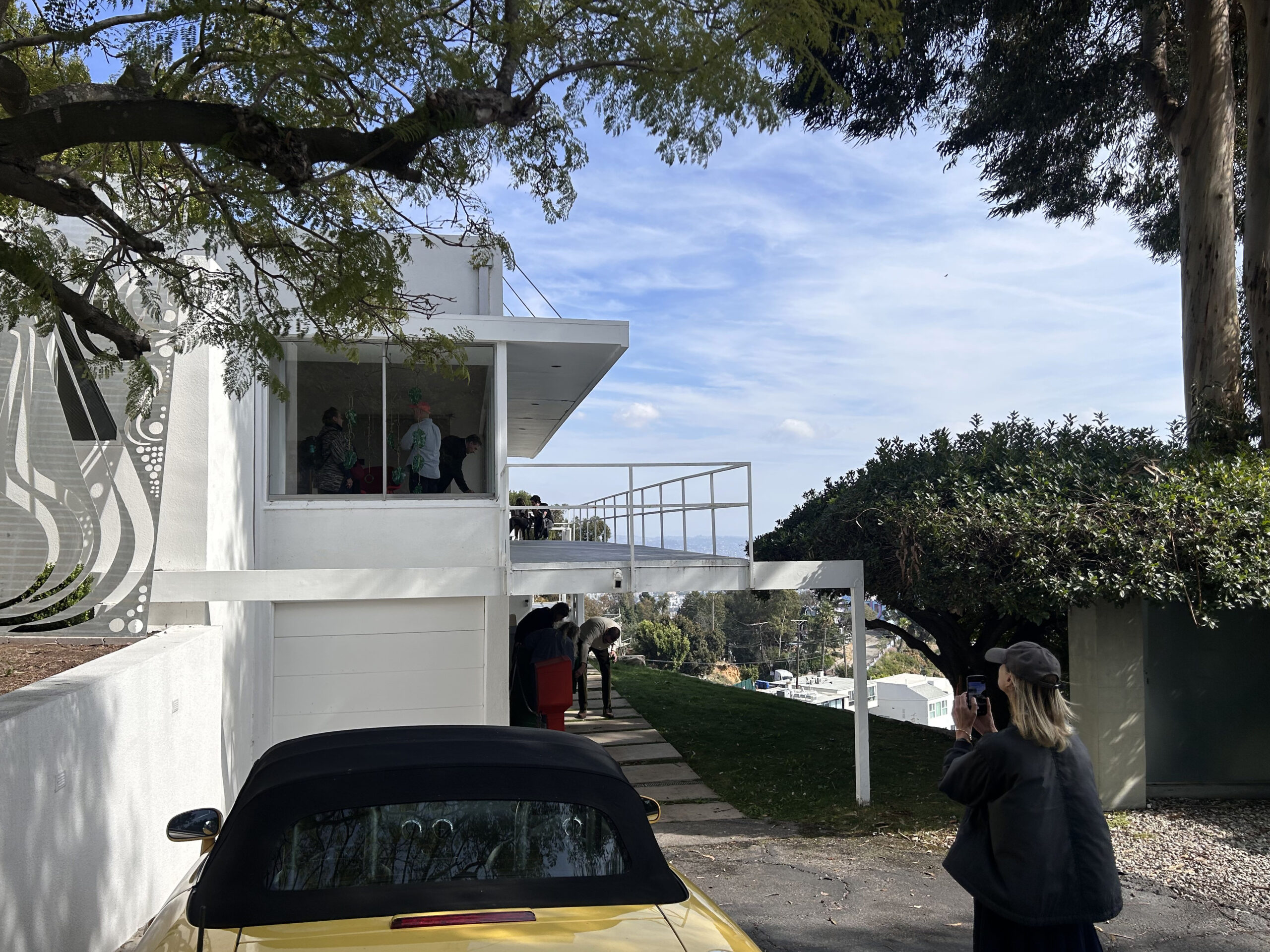 Emma Reeves takes a picture of Blue Heights Arts & Culture with Tyler Murphy upstairs and Rita McBride below.