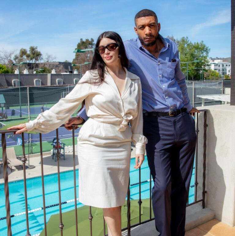 Ariana Papademetropoulos and Honor Titus at the 2026 Artadia tennis fundraiser in front of the tennis court