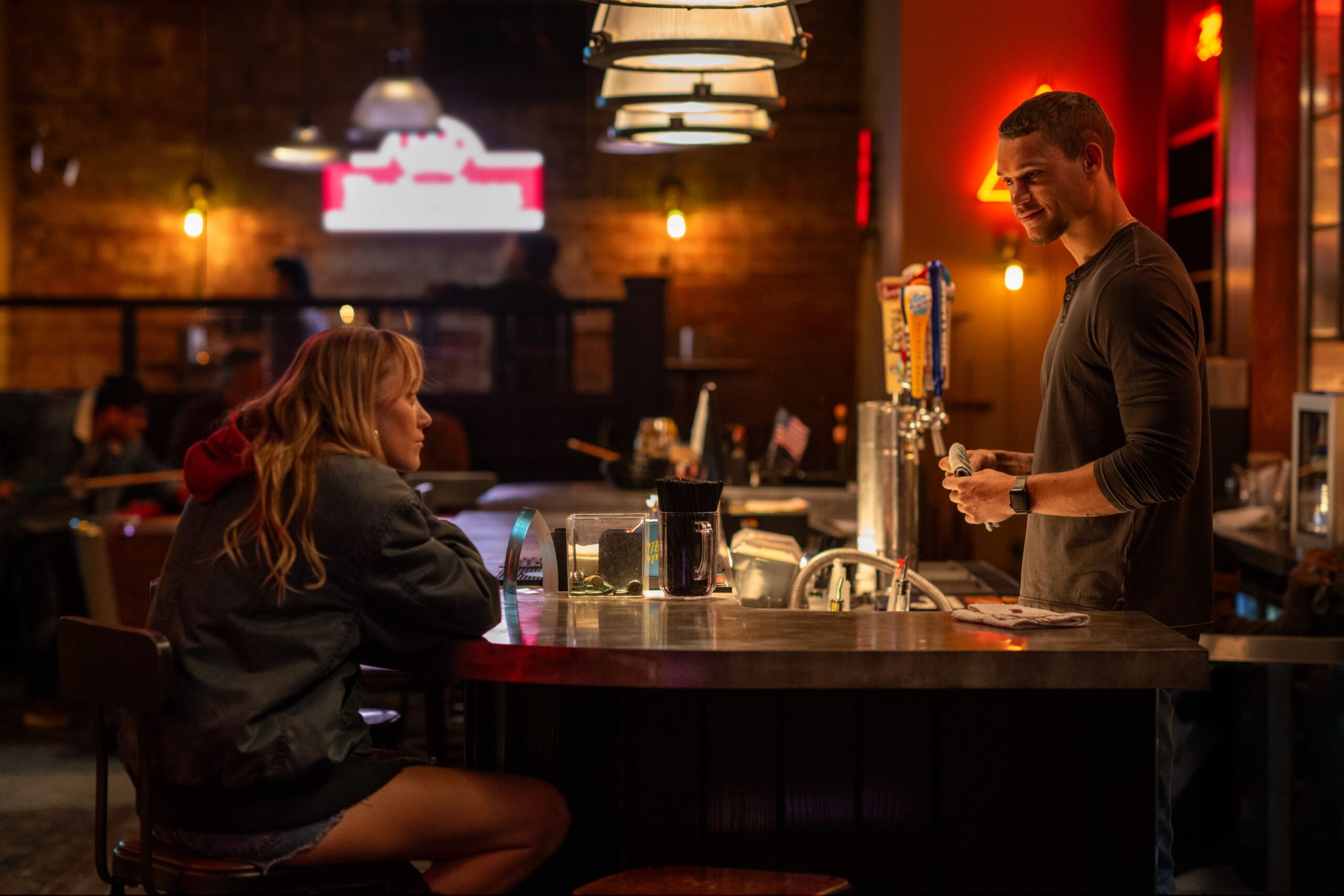 (from left) Kenna Rowan (Maika Monroe) and Ledger Ward (Tyriq Withers) in REMINDERS OF HIM, directed by Vanessa Caswill.