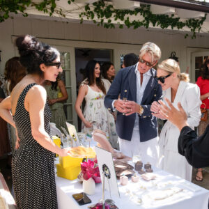 Stewart Shining and Lily Hahn Shining try on jewelry on the patio at San Ysidro Ranch