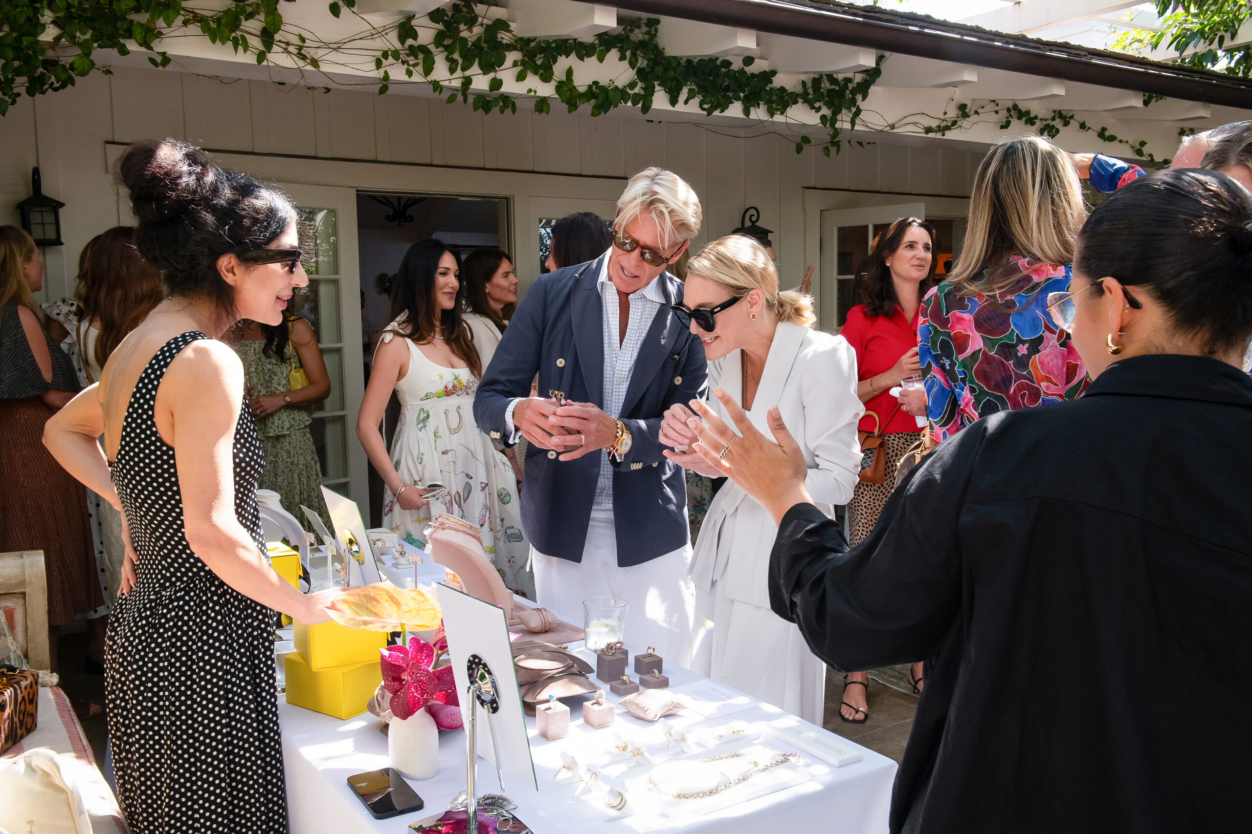 Stewart Shining and Lily Hahn Shining try on jewelry on the patio at San Ysidro Ranch