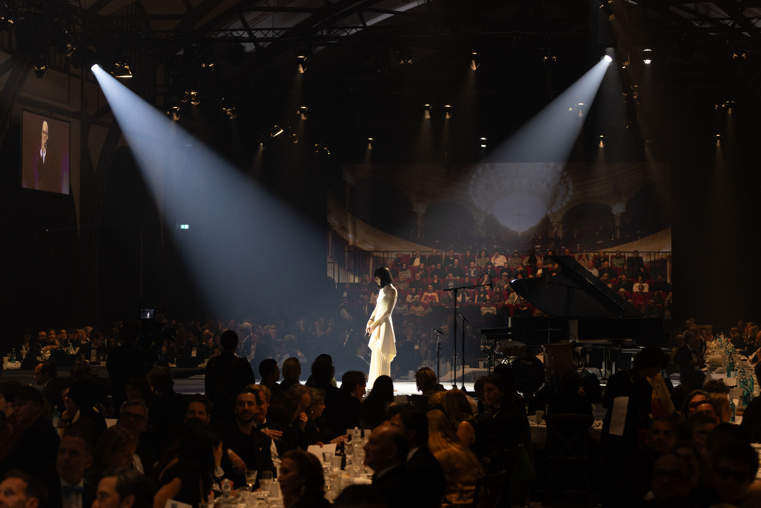 Alice Sara Ott performs at the first annual Hamburger Banhoff gala, with light shining down and guests gathered to witness the performance