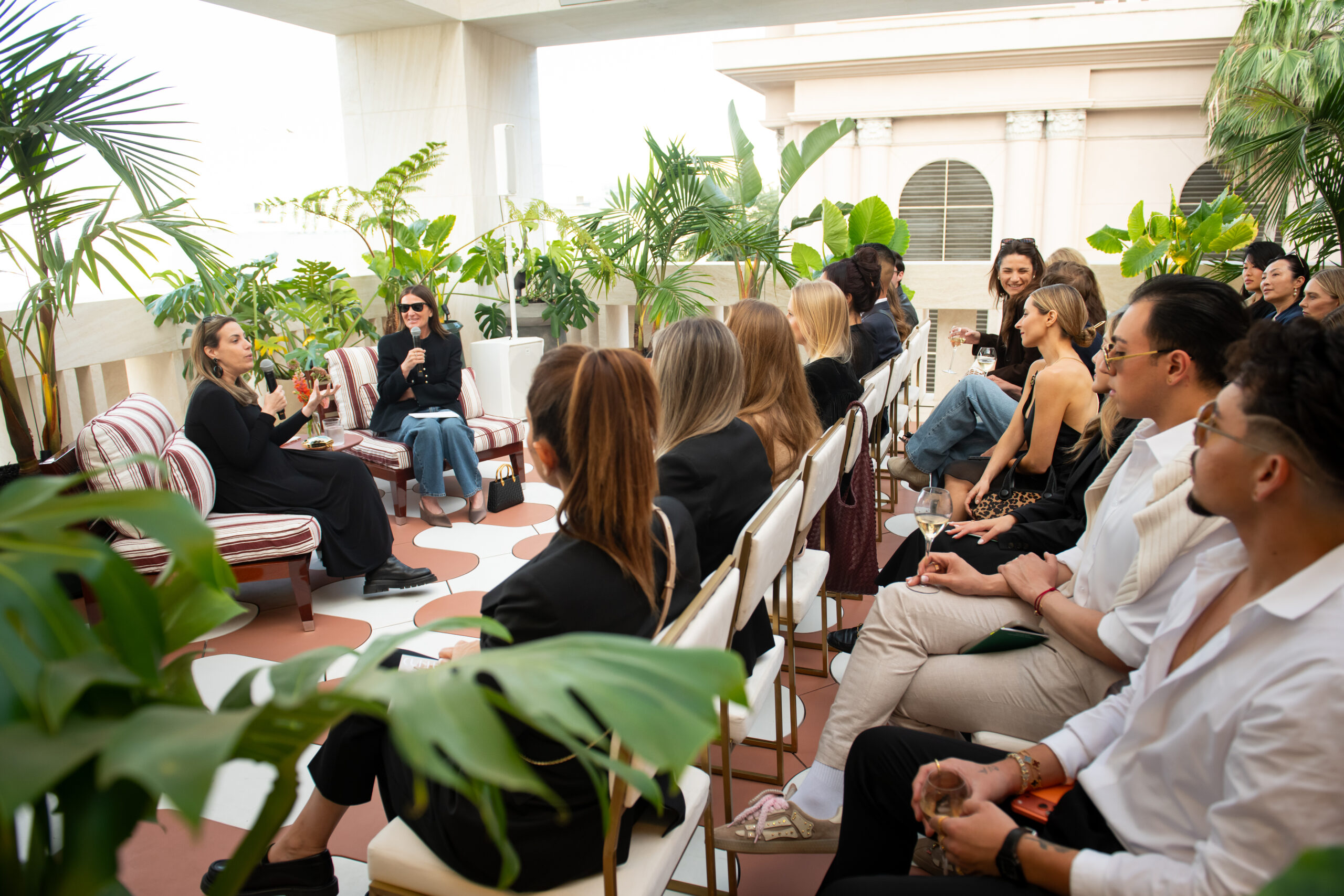 Mary Katrantzou and Sarah Harrelson speak on a panel at the Bvlgari Rodeo Drive boutique with a crowd of guests