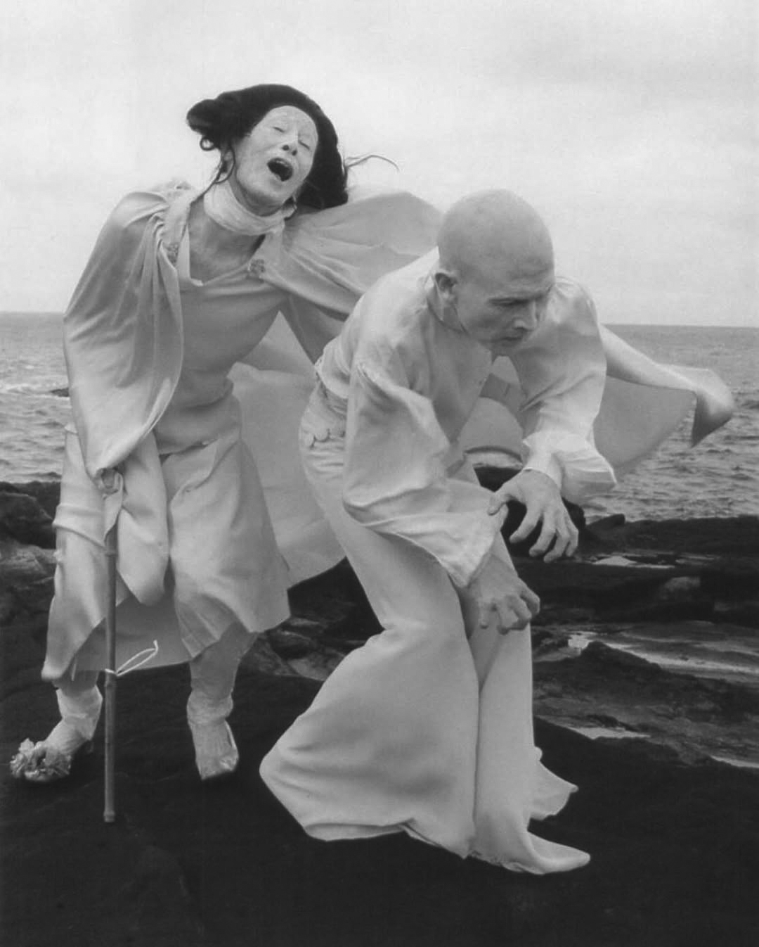 Clowns gesture on a black sand beach