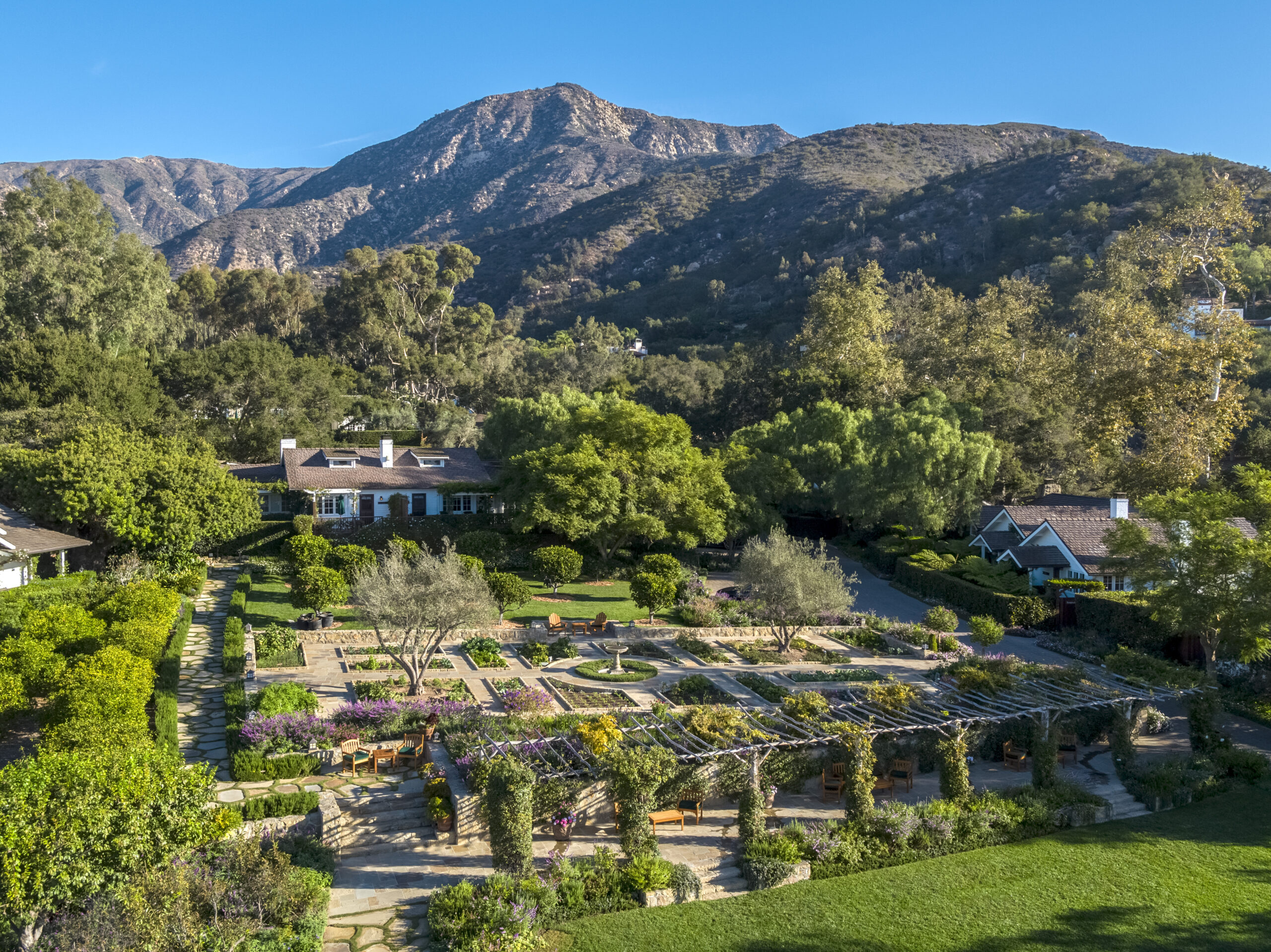 The gardens at San Ysidro Ranch against rolling hills, sunshine, and lush greenery