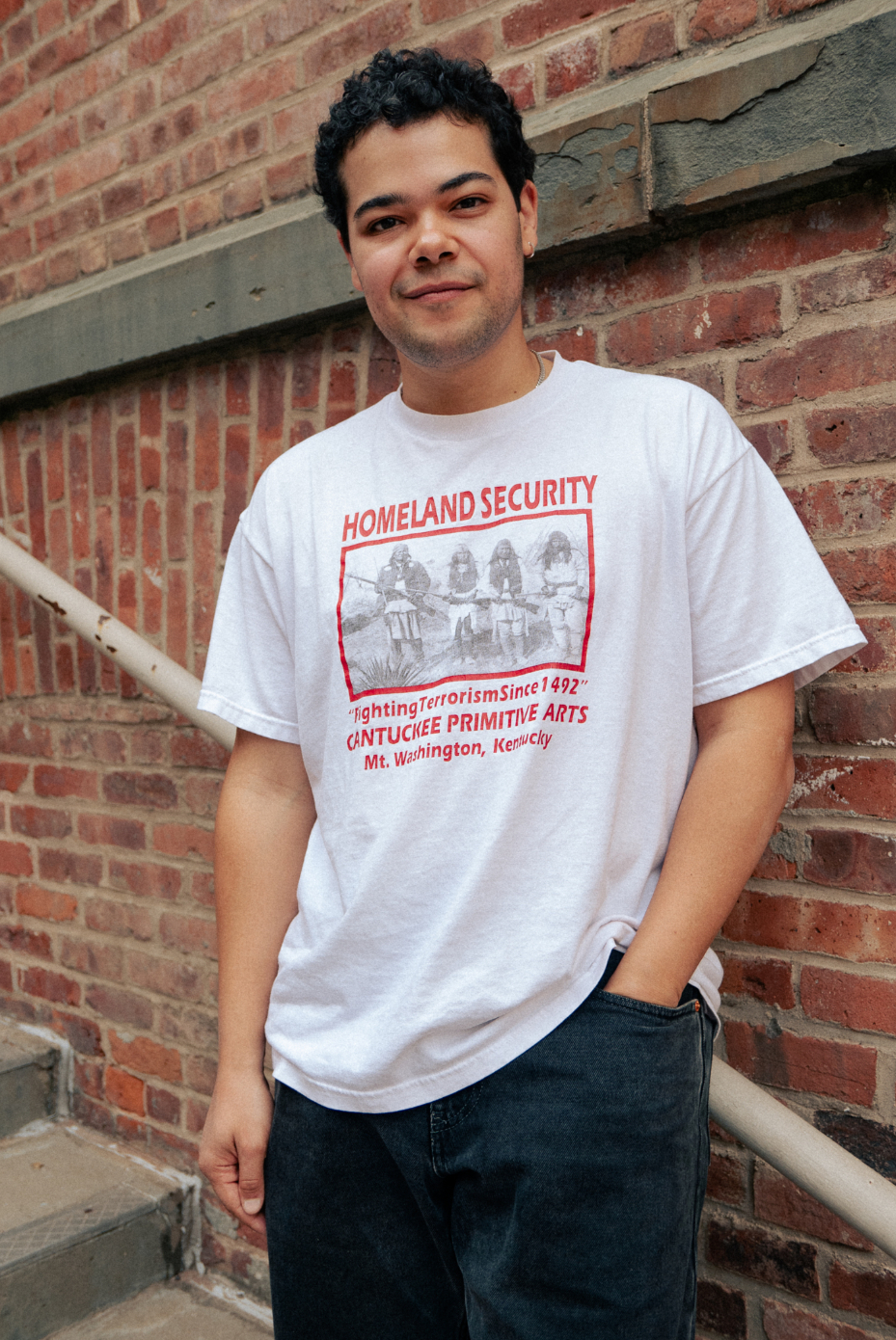 Esteban Jefferson in front of brick wall at MoMA PS1