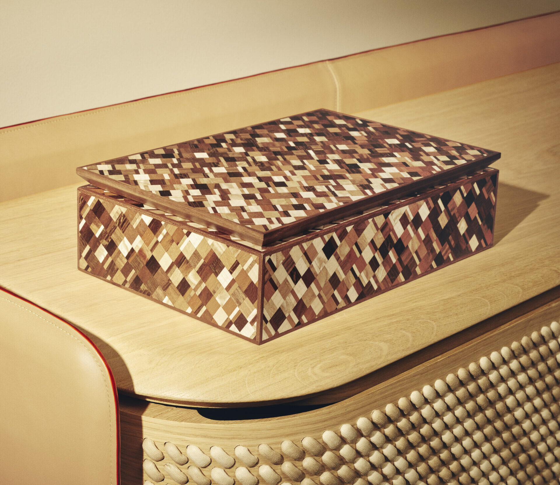 Louis Vuiitton's Jean Brieuc Damier Box sits in situ on a wooden chaise