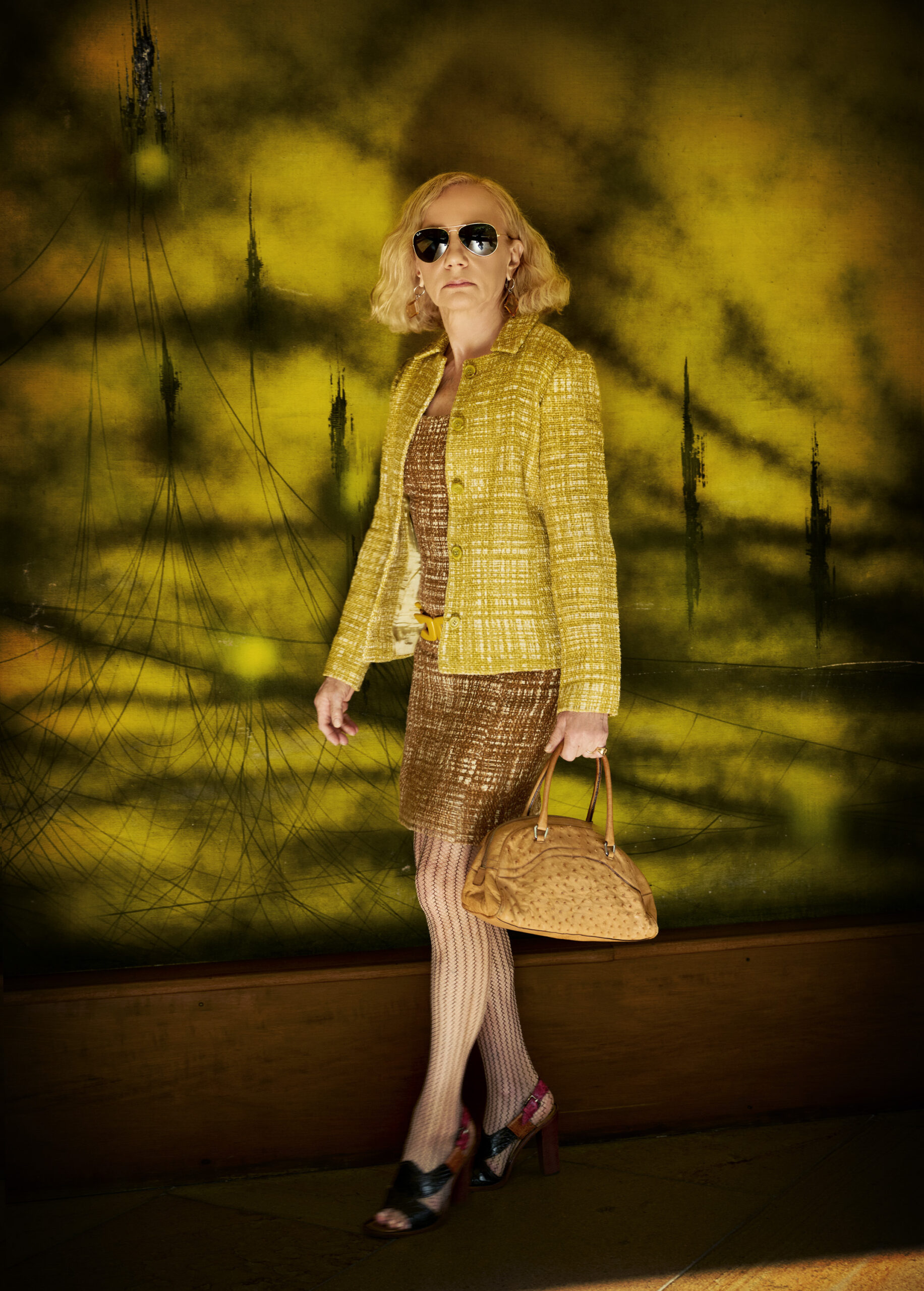 Prada collector Nicoletta Santoro poses for a portrait full Prada in her Milan home