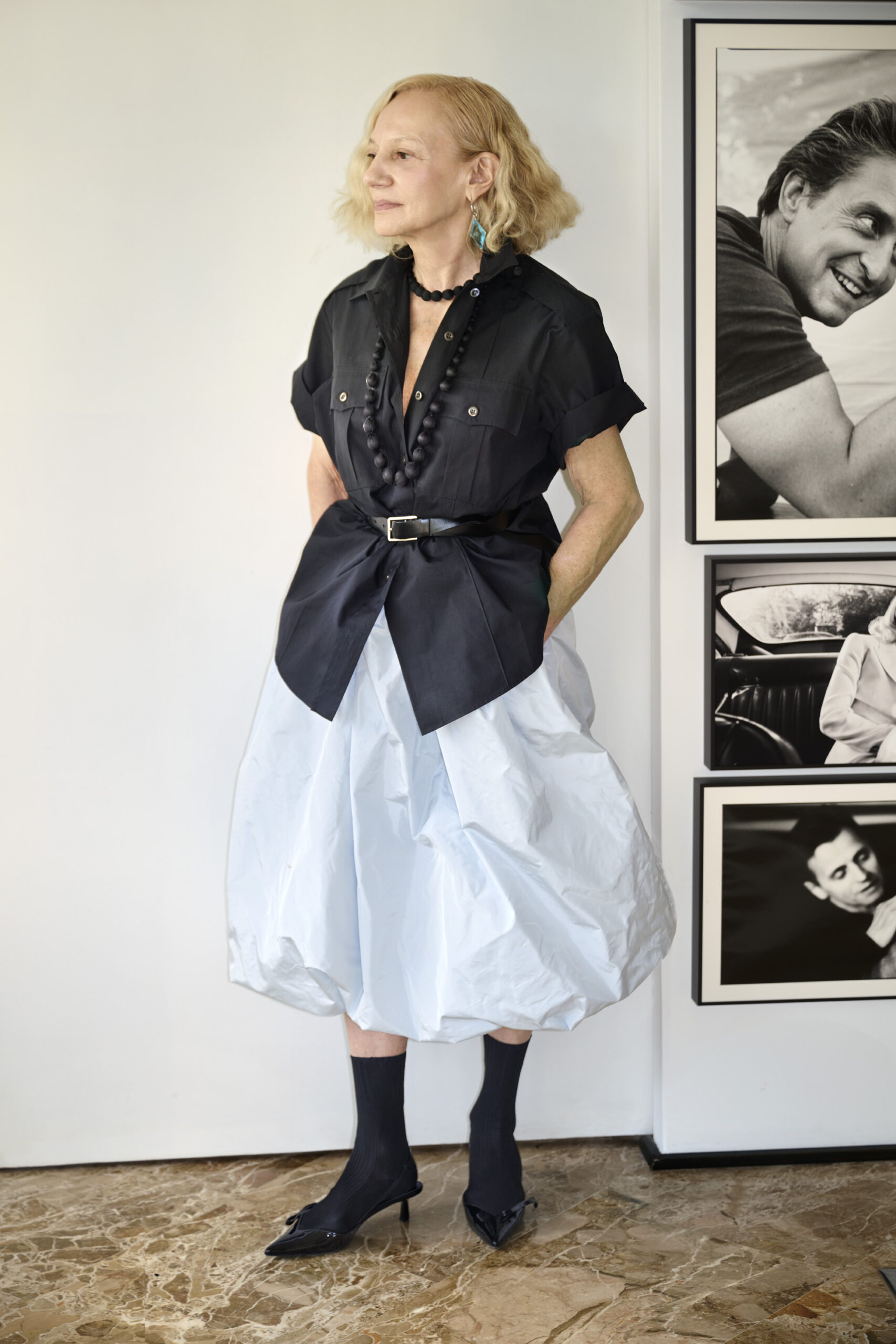 Prada collector Nicoletta Santoro poses for a portrait full Prada in her Milan home